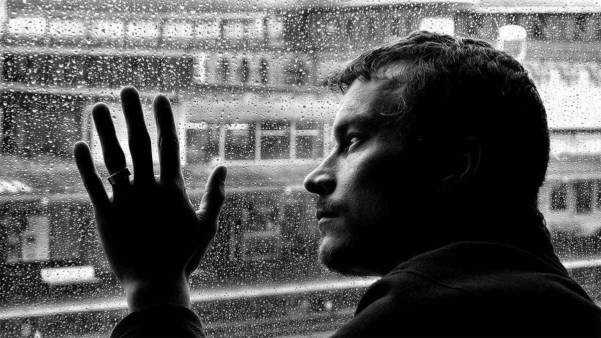 mann-depresionen-regen-auf-scheibe