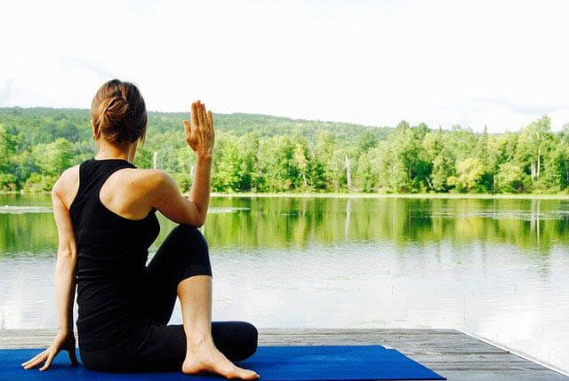 frau macht yoga am see klein