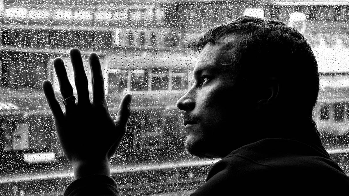 mann-regen-scheibe-schwarz-weiss